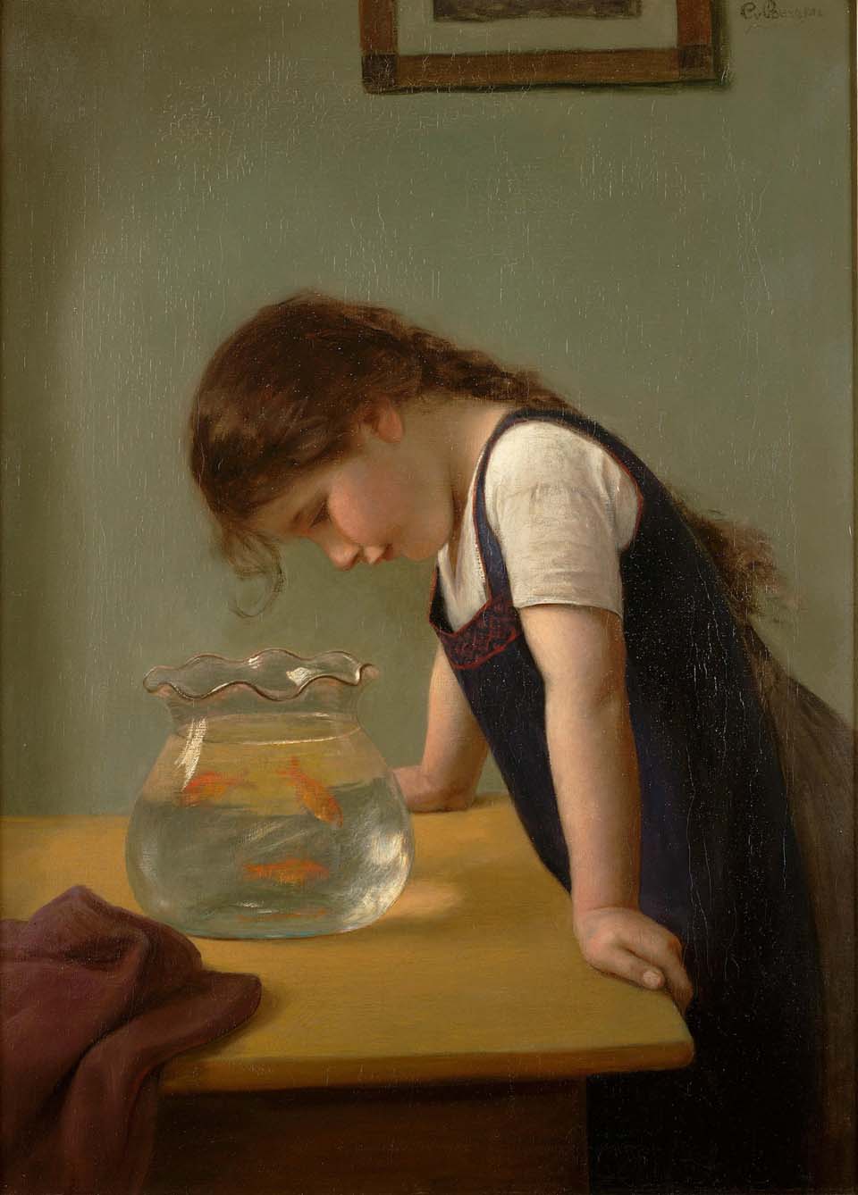 A girl looking into a goldfish bowl