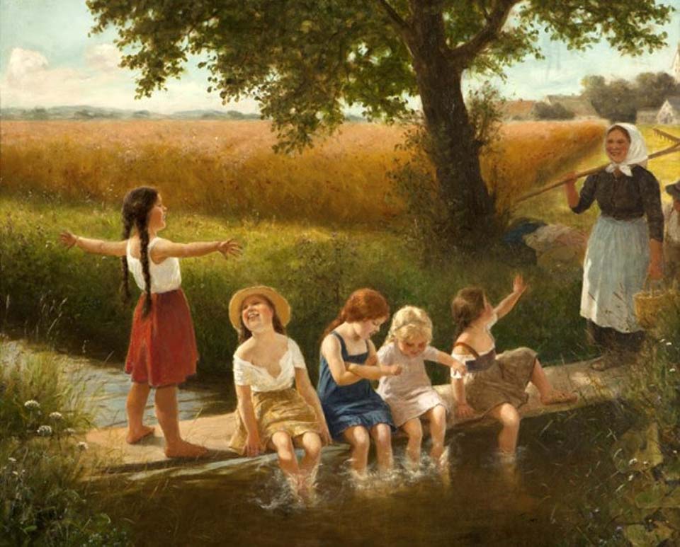 Children playing in a stream in a rural landscape