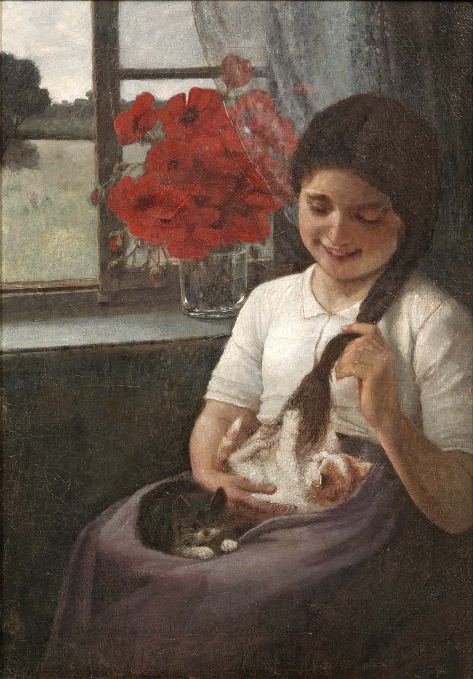 Girl playing with two kittens