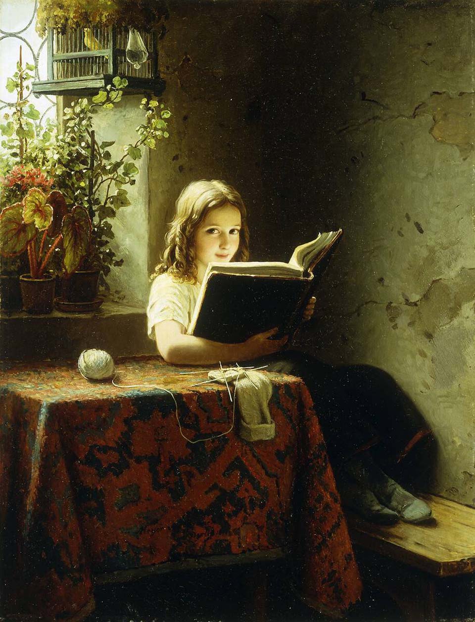 A young girl reading at a table